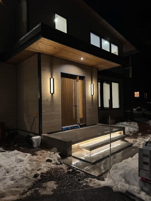 LED step lighting and exterior wall sconces installed at a Tahoe home entry